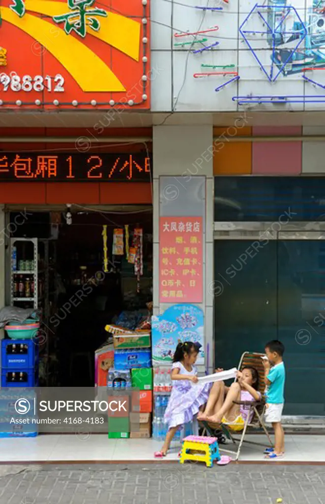 China, Shanghai, Street Scene With Children In Front Of Store
