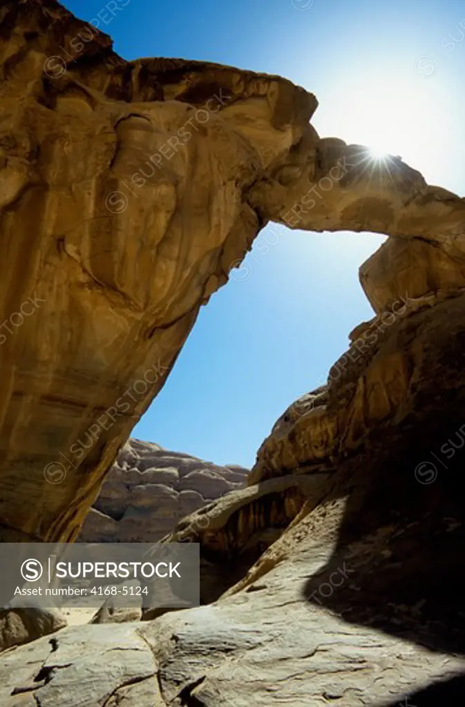 jordan, wadi rum, um frouth rock bridge, sandstone formation, sunburst