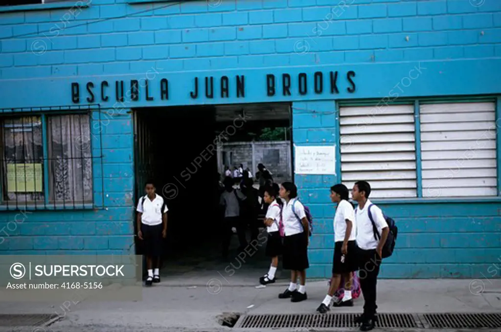 honduras, roatan island, coxen's hole, schoolchildren in front of school