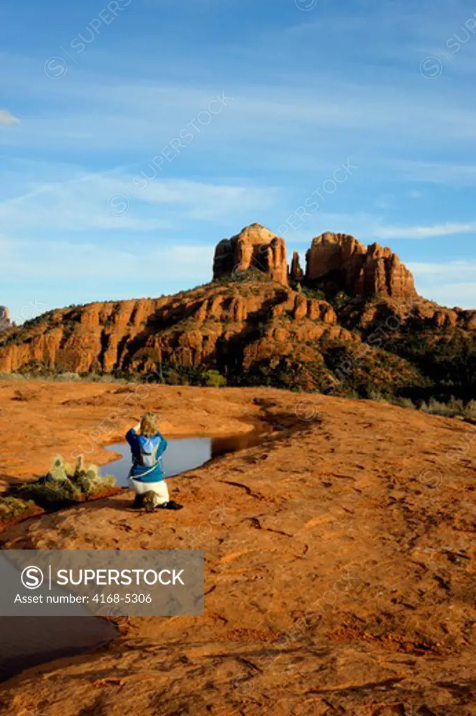 usa, arizona, sedona, view of cathedral mountain, woman photographing