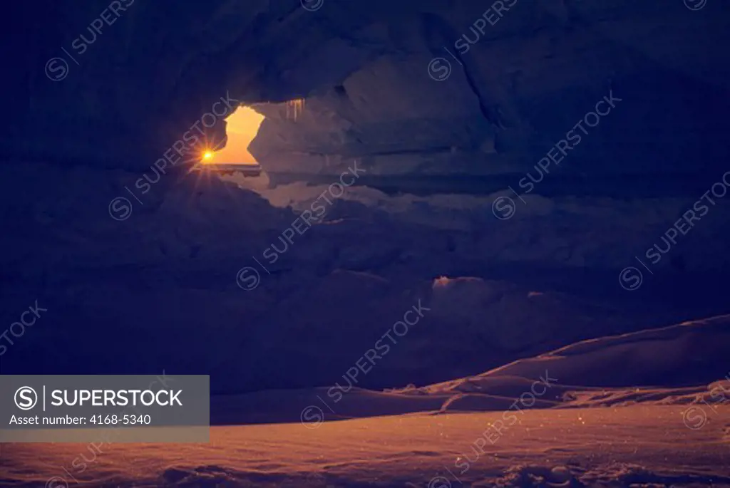 antarctica, atka iceport, iceberg with arch, midnight sunshine, sunburst