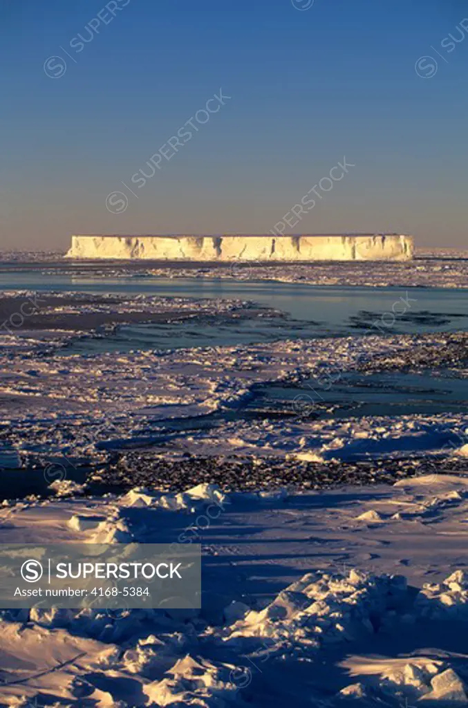 antarctica, weddell sea, pack ice, tabular iceberg in evening sunshine