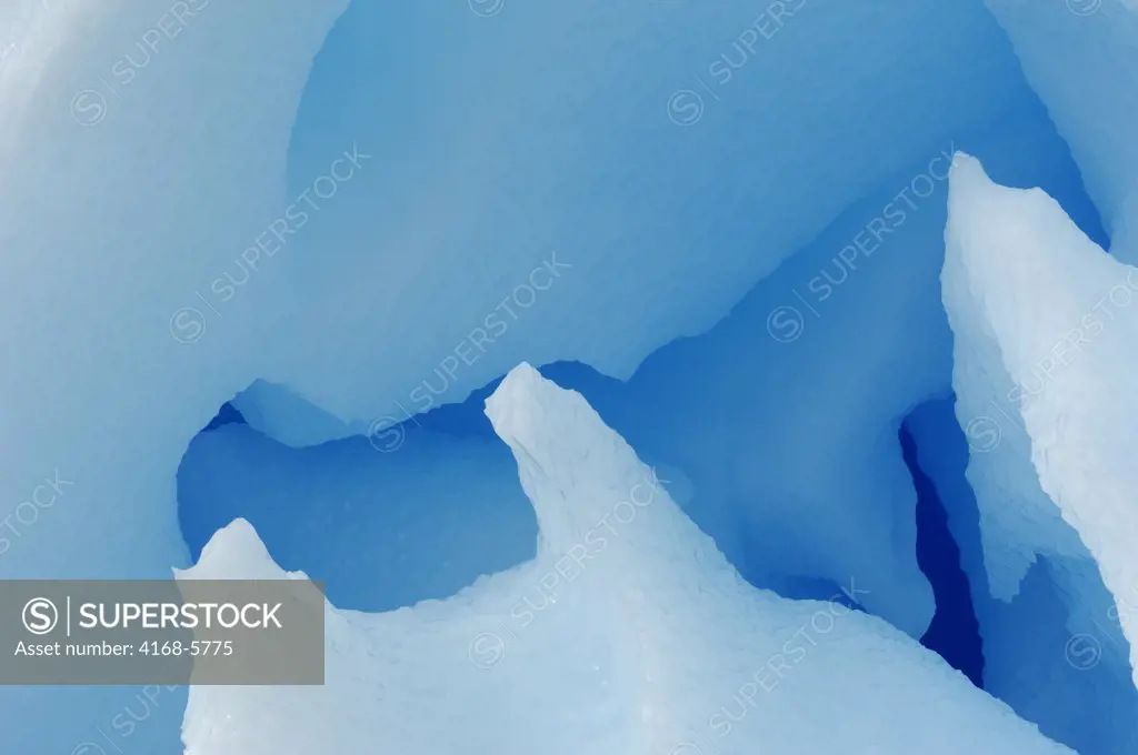 ANTARCTICA, ANTARCTIC PENINSULA, PLENEAU ISLAND, BLUE ICEBERG WITH CAVES