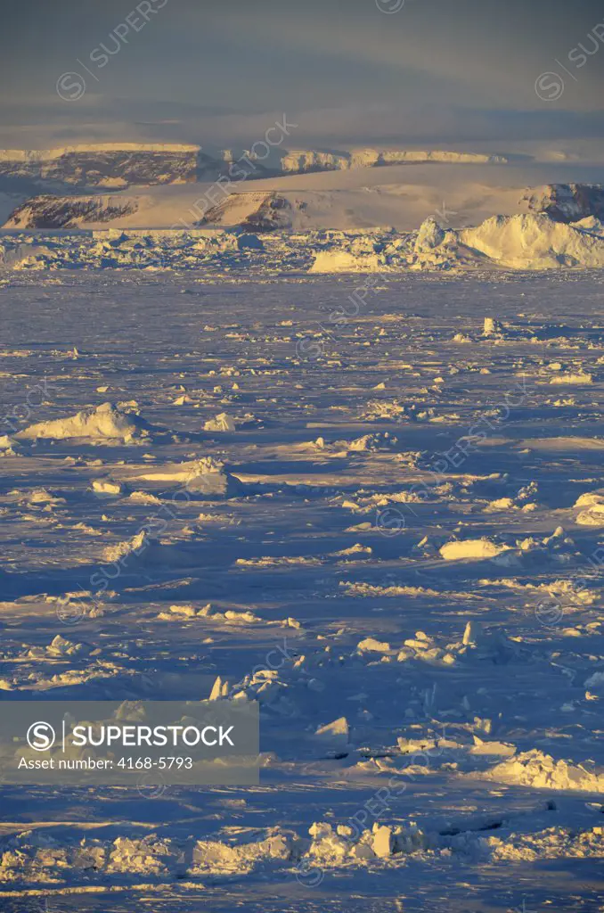 ANTARCTICA, WEDDELL SEA, FAST ICE AND RIDGED SEA ICE WITH SNOW HILL ISLAND IN BACKGROUND, EVENING