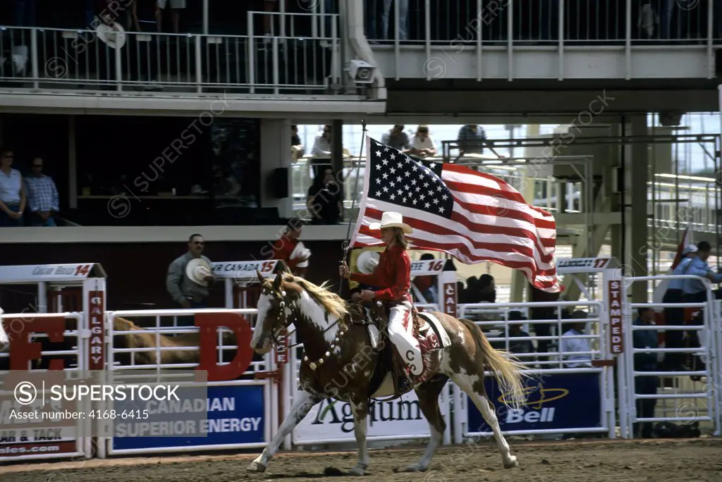 canada, alberta, calgary, calgary stampede, stampede scene, showrider with american flag, opening ceremony
