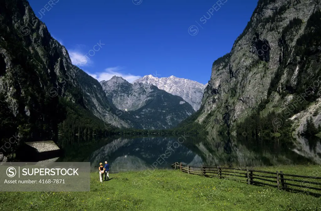 Germany, Bavaria, Berchtesgaden, Konigsee Area, Obersee, Fischunkel Alm, two people on meadow