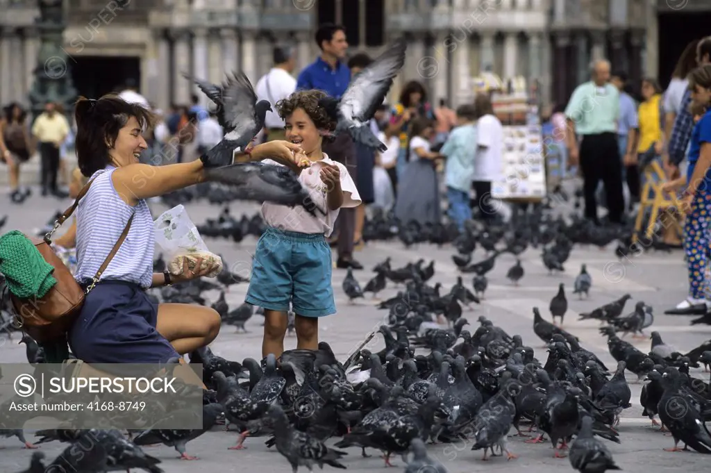 Italy, Venice, San Marco Quarter, St, Mark's Square, St. Mark's cathedral, Tourists feeding pigeons