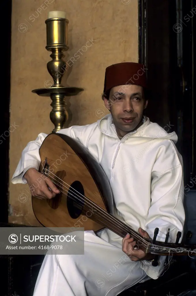Morocco, Marrakech, Medina, Street Scene, Man Playing Ouod (Lute)