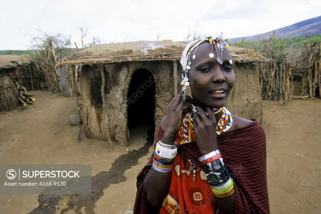 Tanzania, Near Ngorongoro Crater, Masai Village,  Young Woman In Front Of Hut