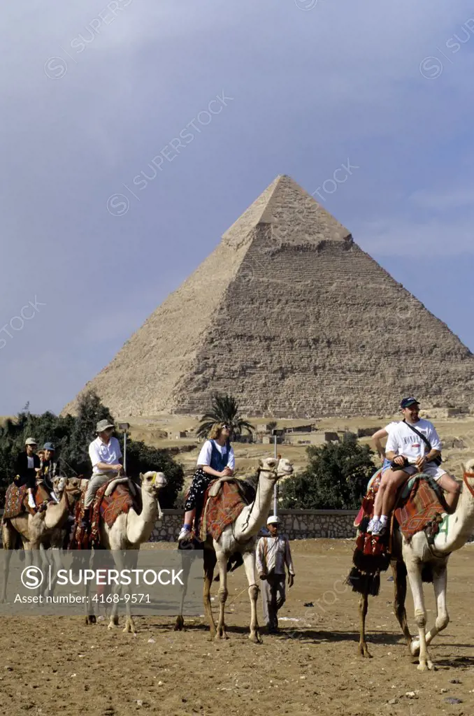 Egypt, Cairo, Giza, Tourists On Camels, Chefren Pyramid In Background