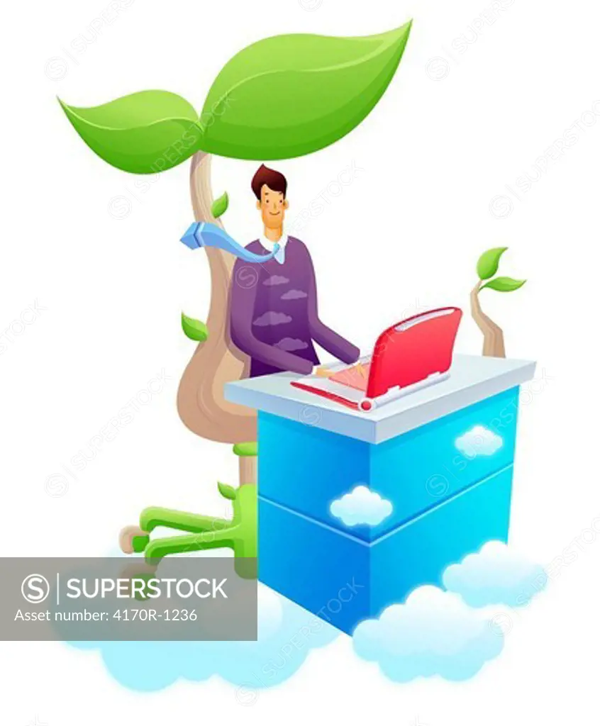 Businessman using a laptop under a tree