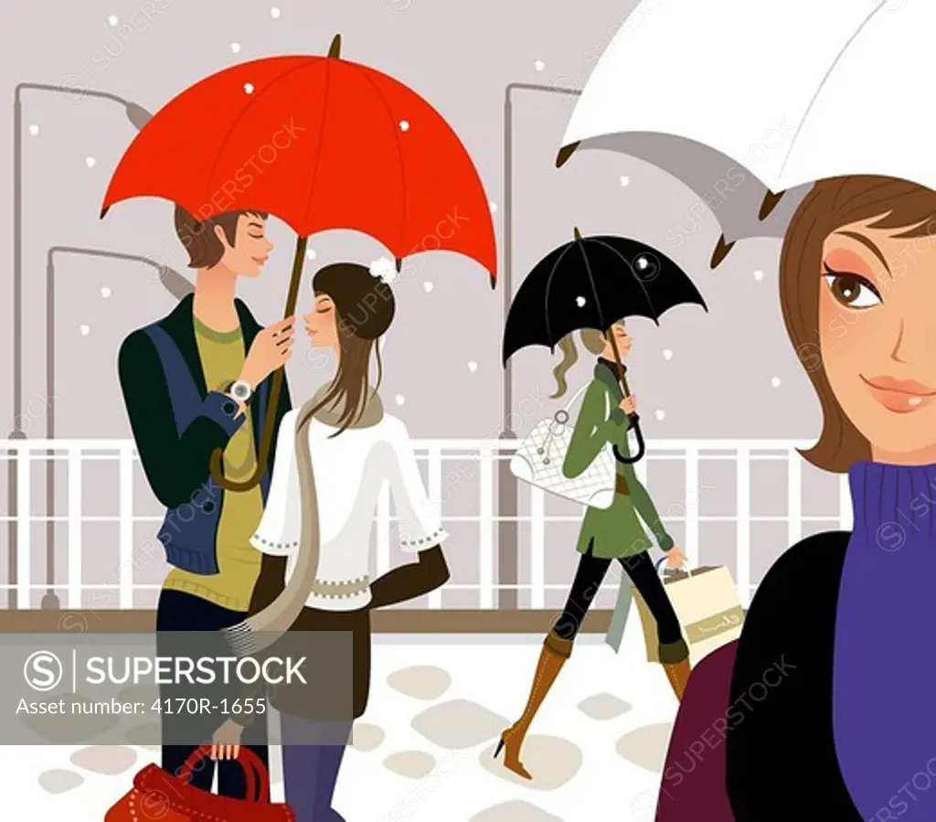 Two women and a couple holding umbrellas in snowing