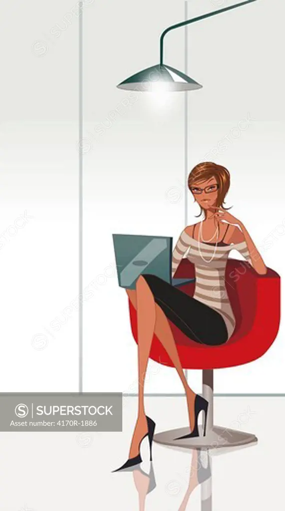 Portrait of a businesswoman sitting on an office chair and using a laptop