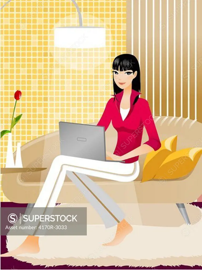 Portrait of a woman sitting on a couch and using a laptop