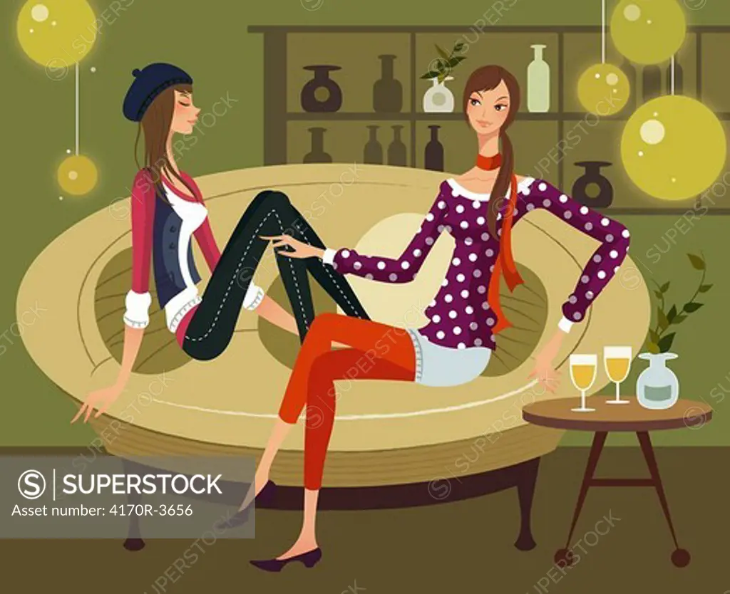 Two women sitting together on a couch