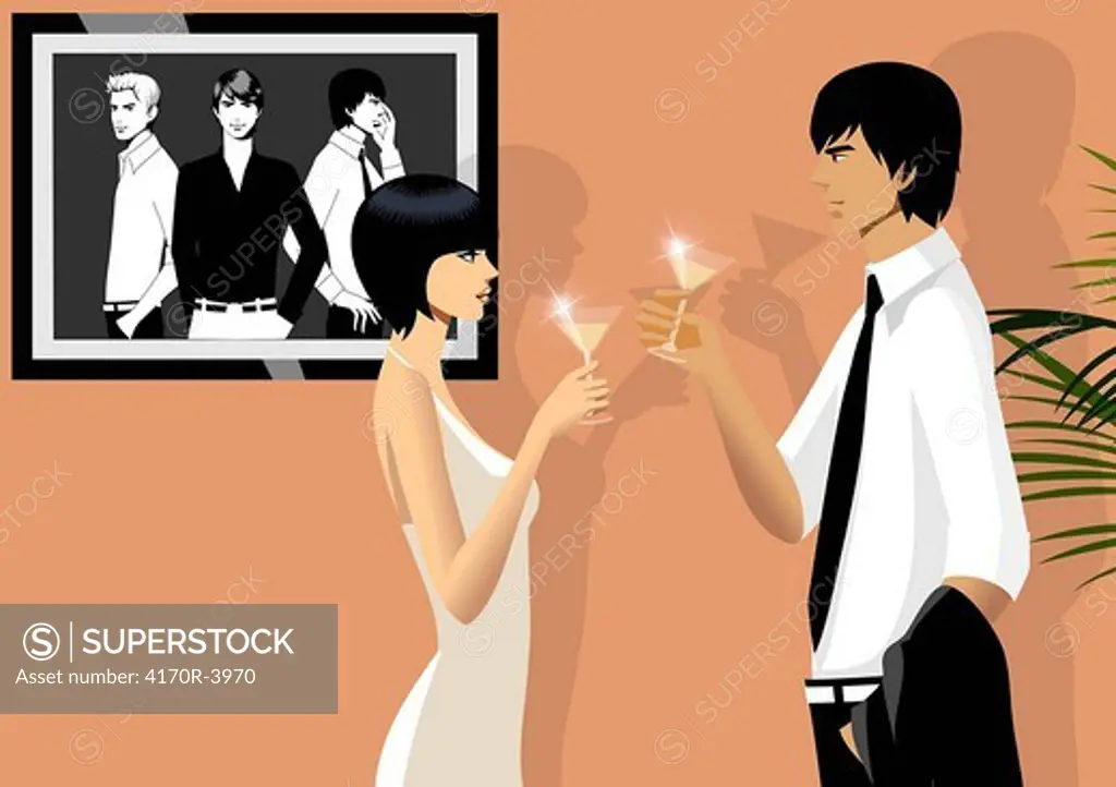 Side profile of a couple toasting with martini glasses
