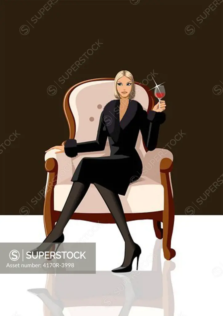 Woman sitting in an armchair and holding a glass of red wine