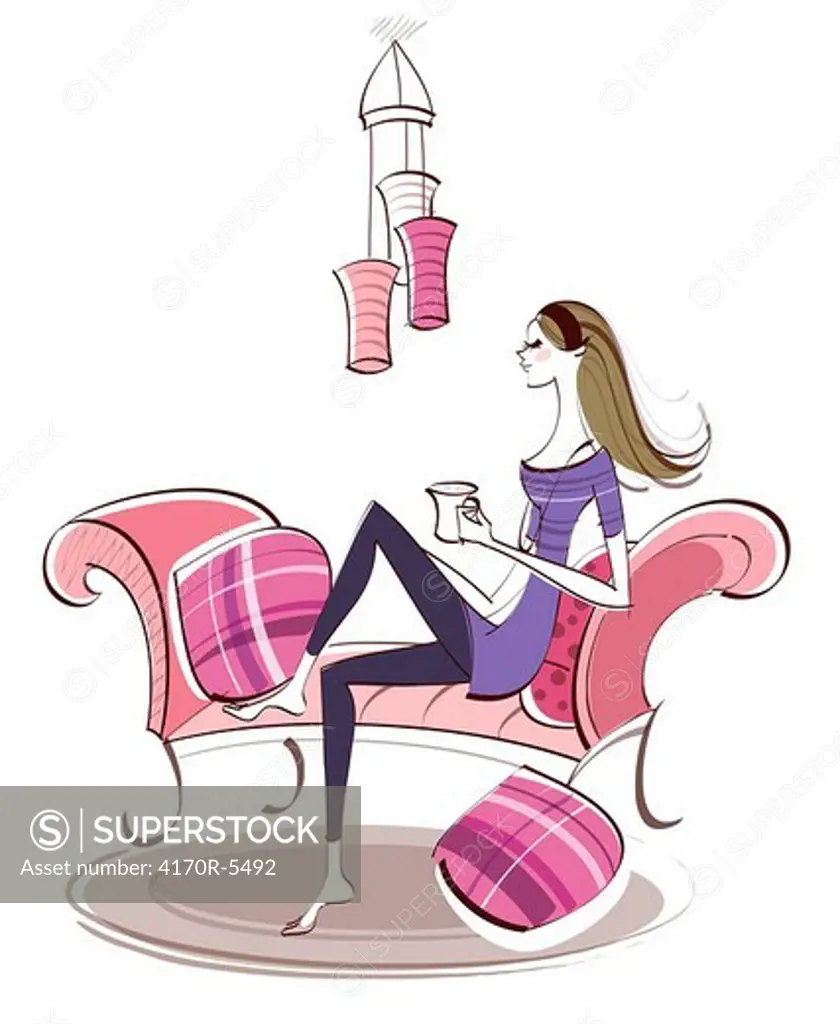 Side profile of a woman sitting on a couch and holding a cup of coffee