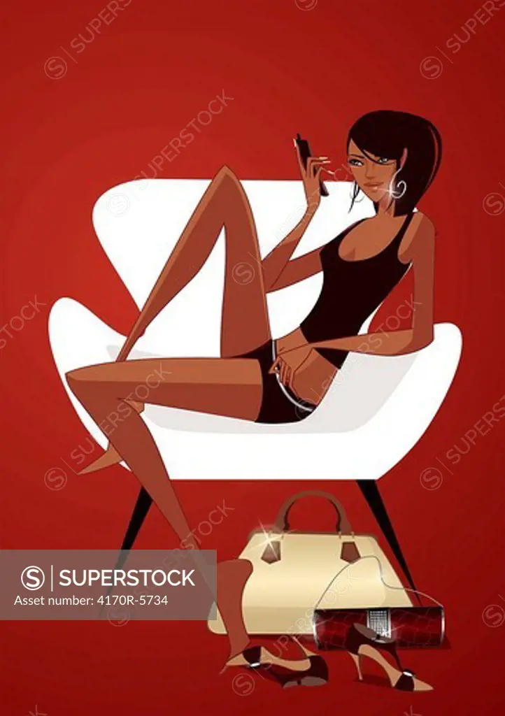 Side profile of a woman sitting in an armchair and holding a mobile phone