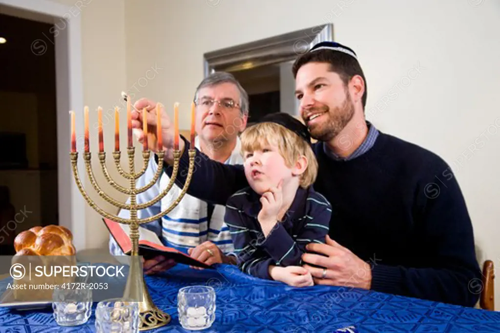 Jewish family lighting Chanukah menorah