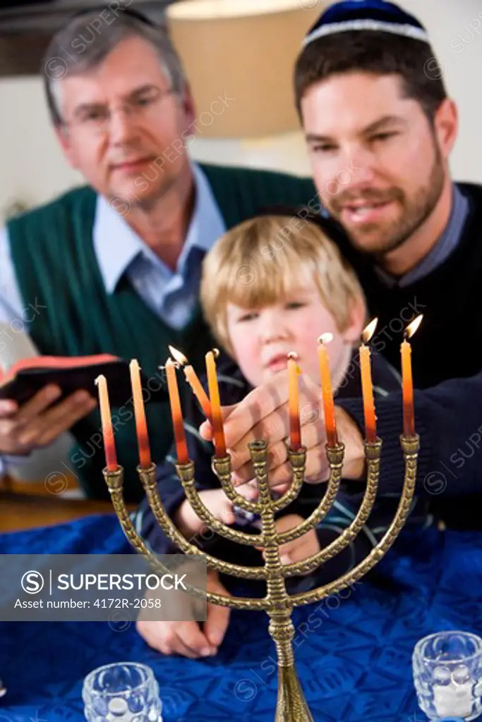 Jewish family lighting Chanukah menorah