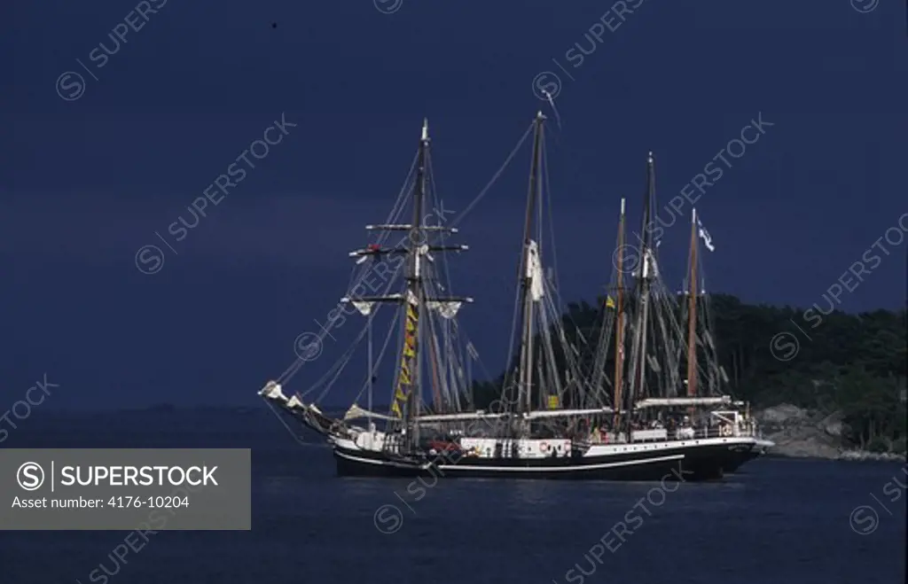 Ship sailing in the sea with blue sky in the background