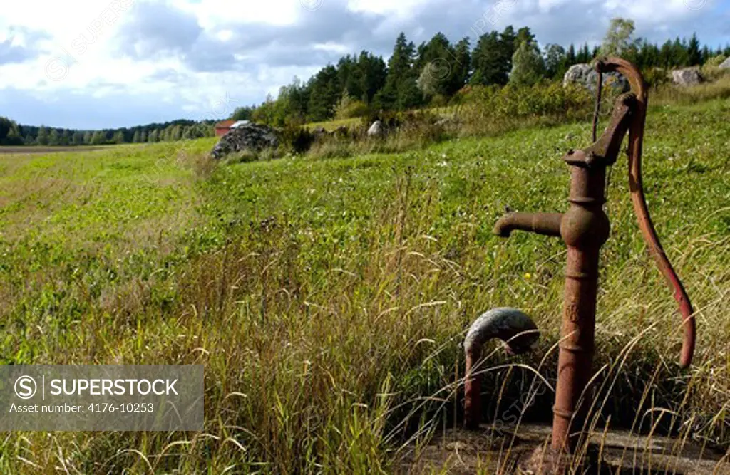 Hand cranked water pump in a field