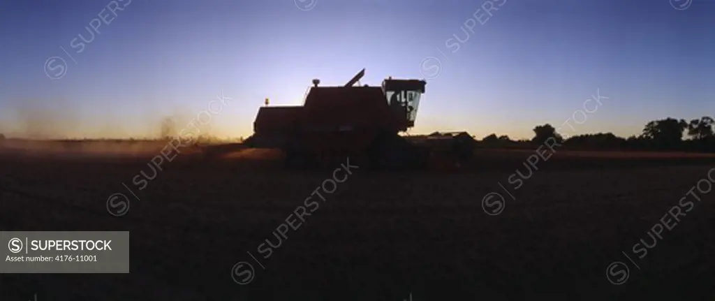 Panoramic view of a tractor ploughing field