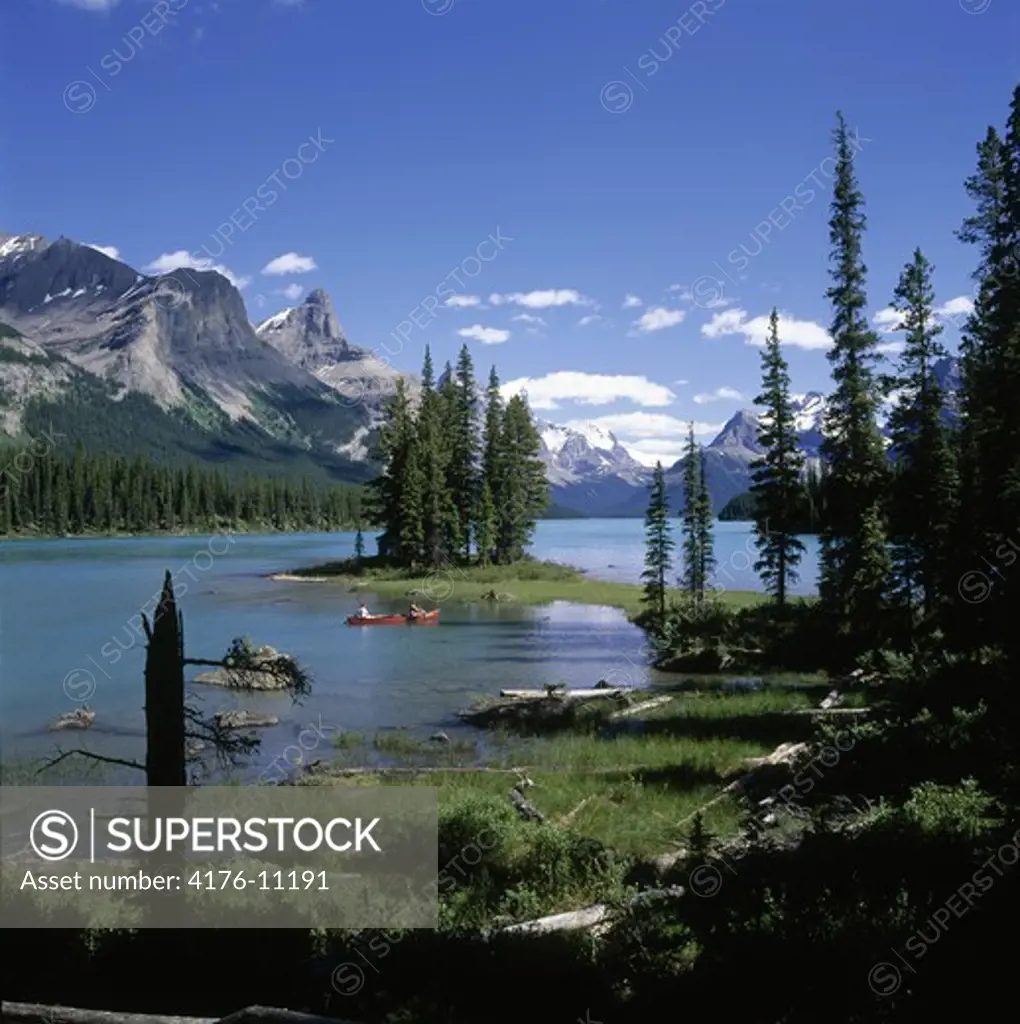 Two people in a canoe, Maligne Lake, Jasper National Park, Alberta, Canadian Rockies in Canada.