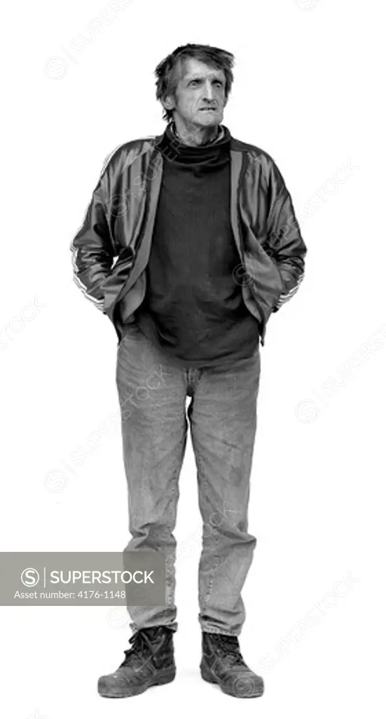 Mature man standing with his hands in his pockets
