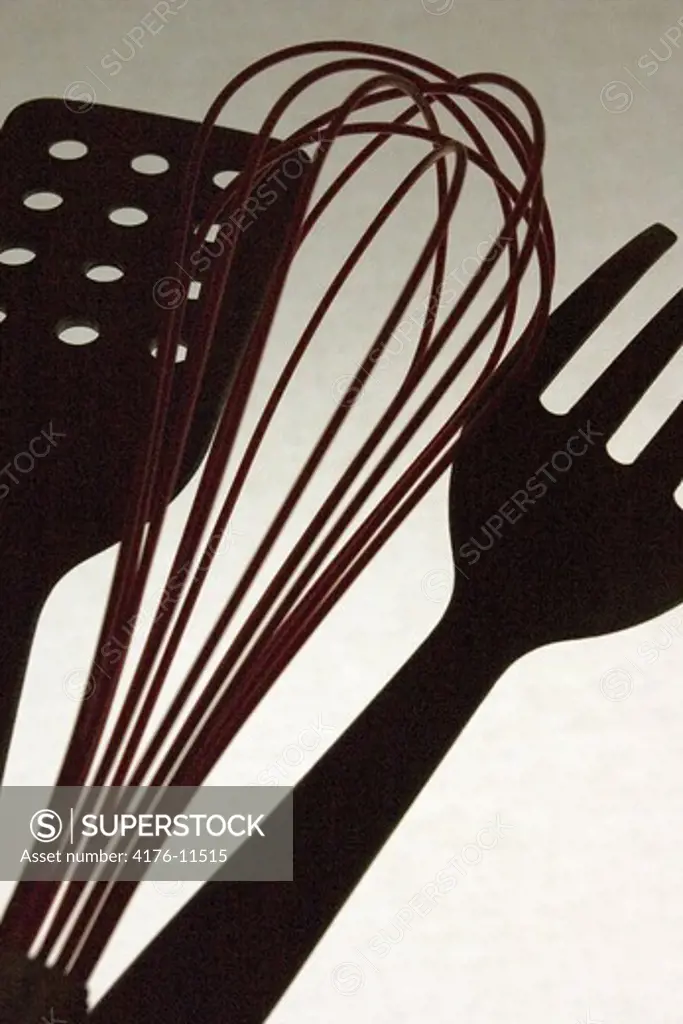 Silhouette of fork, beater and spatula