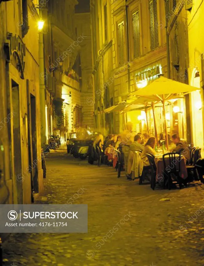 View of people sitting at a restuarant and enjoying dinner