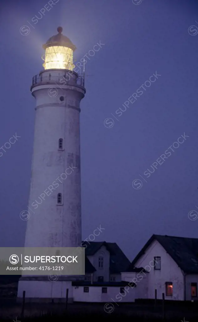 Lighthouse beacons lit up at night
