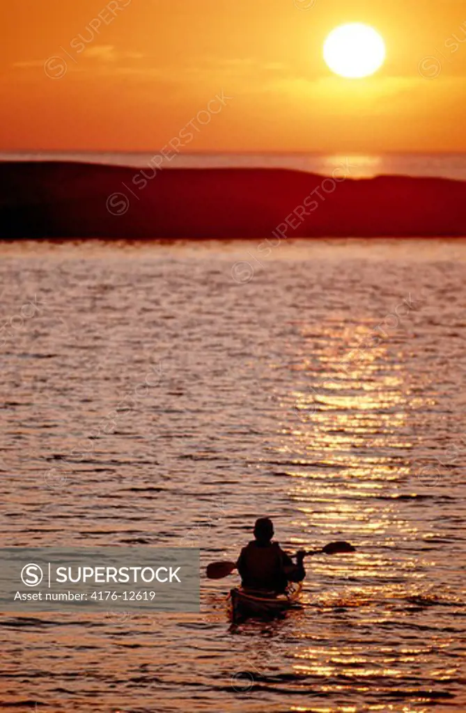 A seakayaker in the ocean at sunset in Bohuslan, Sweden