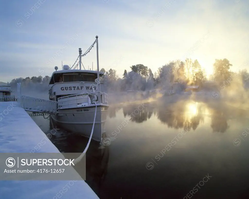 Ferry moored at a snow covered harbor, Dalarna, Sweden