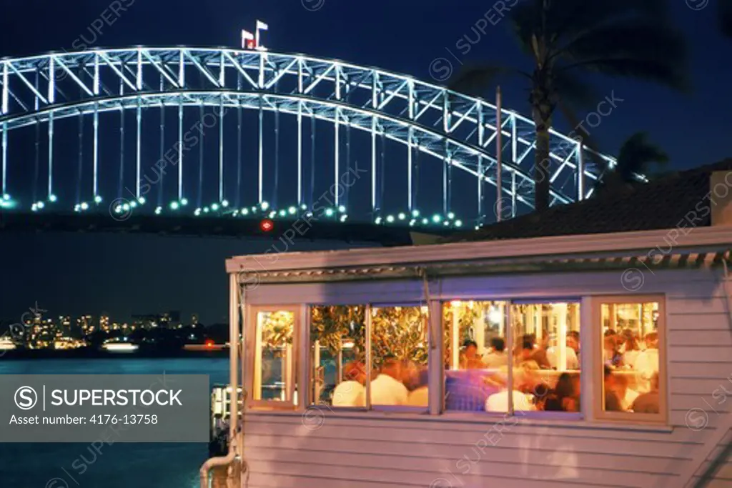 Sails restaurant at McMahons Point on Lavender Bay in North Sydney with Harbor Bridge at night