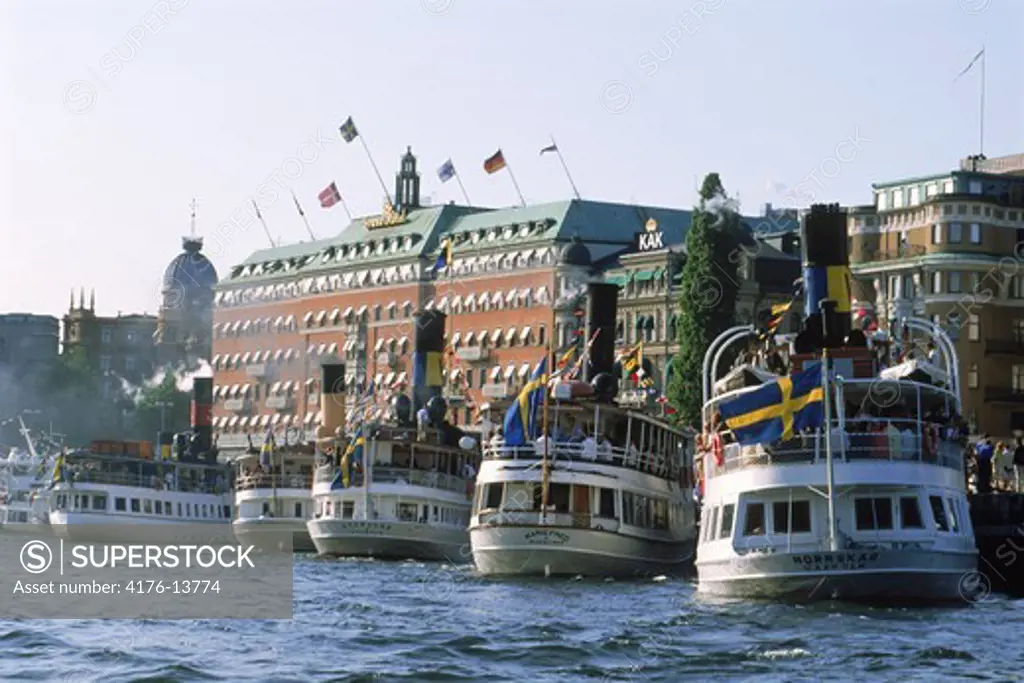 Passengers and steamships on Archipelago Boat Day in Stockholm with Grand Hotel