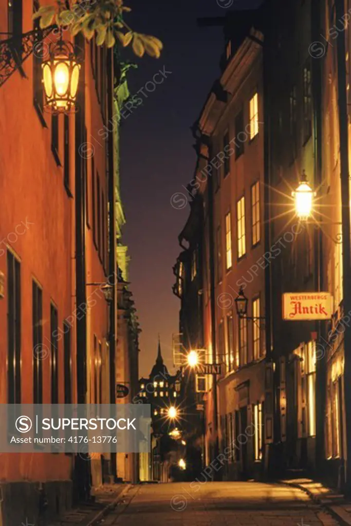Lamplights along cobblestone streets in the Old Town of Stockholm at night