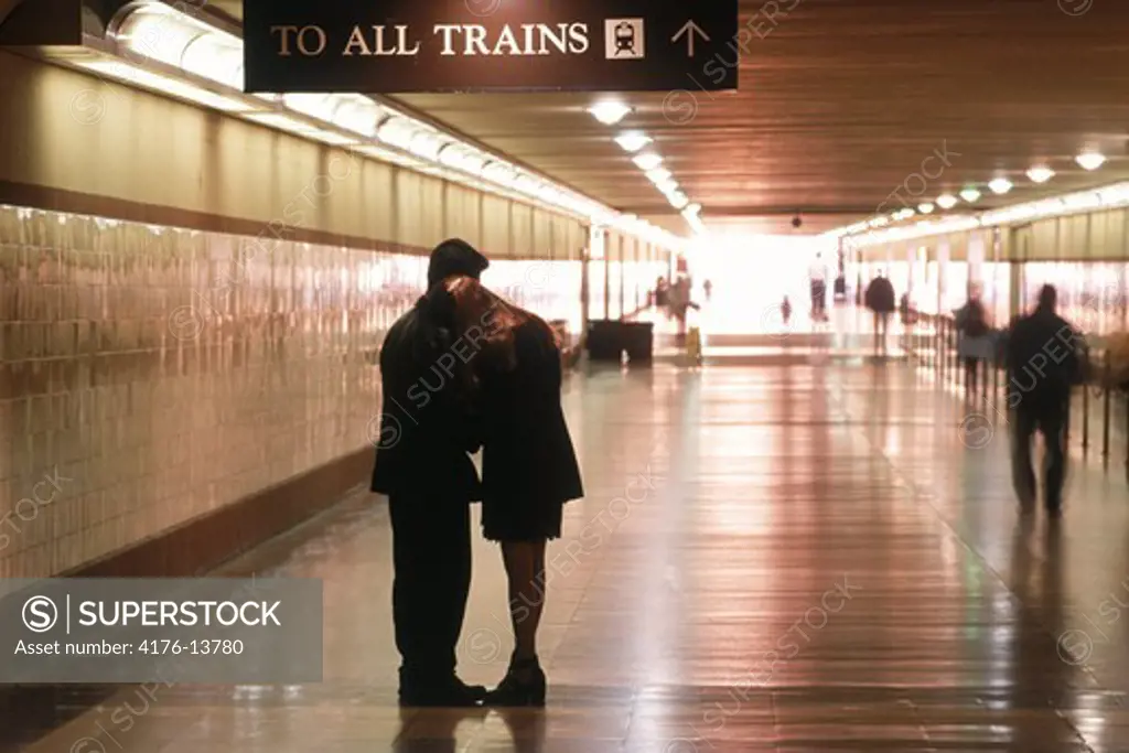 Couple saying goodbye in hallway to departing trains at Union Station in Los Angeles