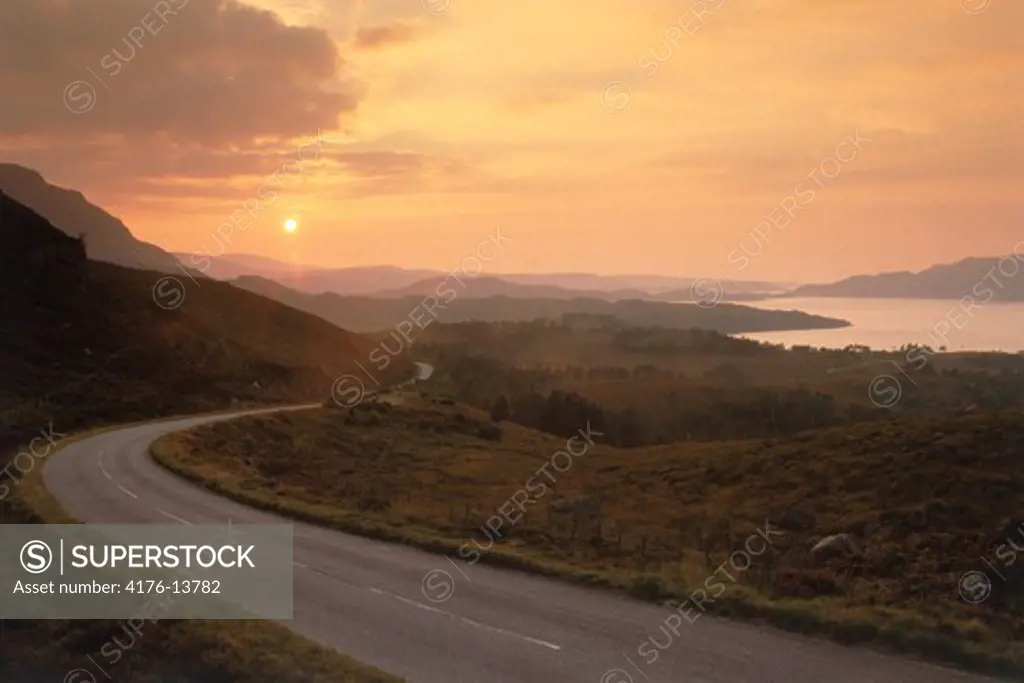 Highway winding along Upper Loch Torridon on the West Coast of Scotland at sunset
