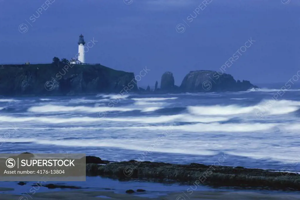 Yaquina Head Lighthouse on headlands at Newport, Oregon over Pacific Ocean