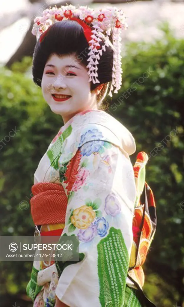 Geisha in Tokyo park in traditional colorful kimono