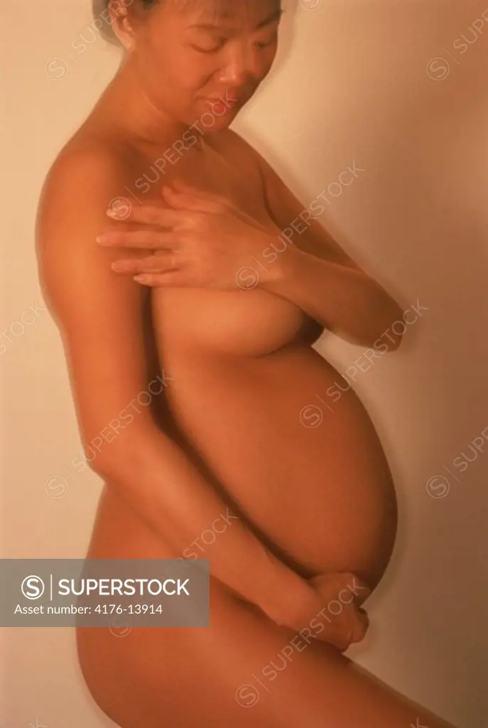 Pregnant lady during 8th month in soft and sensual pose