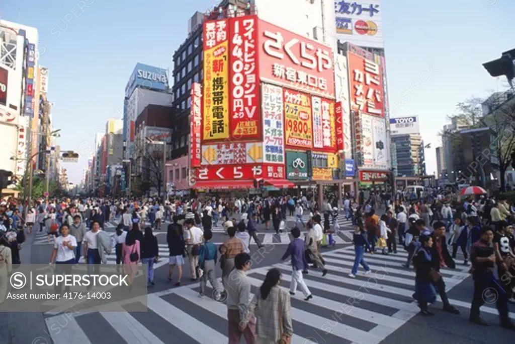 Pedestrians and billboards in Shinjuku district of Tokyo