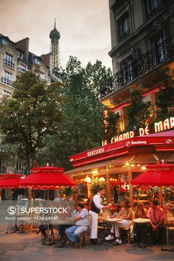 Le Champ De Mars Restaurant on Ave de la Bourdonnais in Paris with Eiffel Tower at dusk