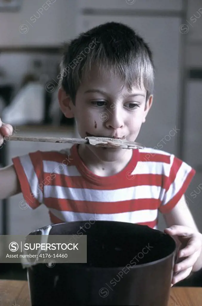 BOY LICKING THE CAKE WHISK CLEAN