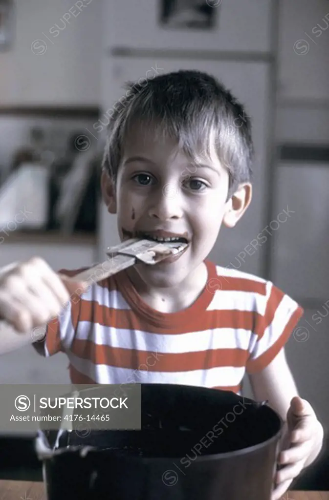 BOY LICKING THE CAKE WHISK CLEAN