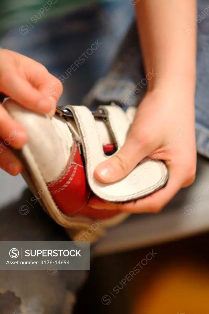 A person taking off the shoe