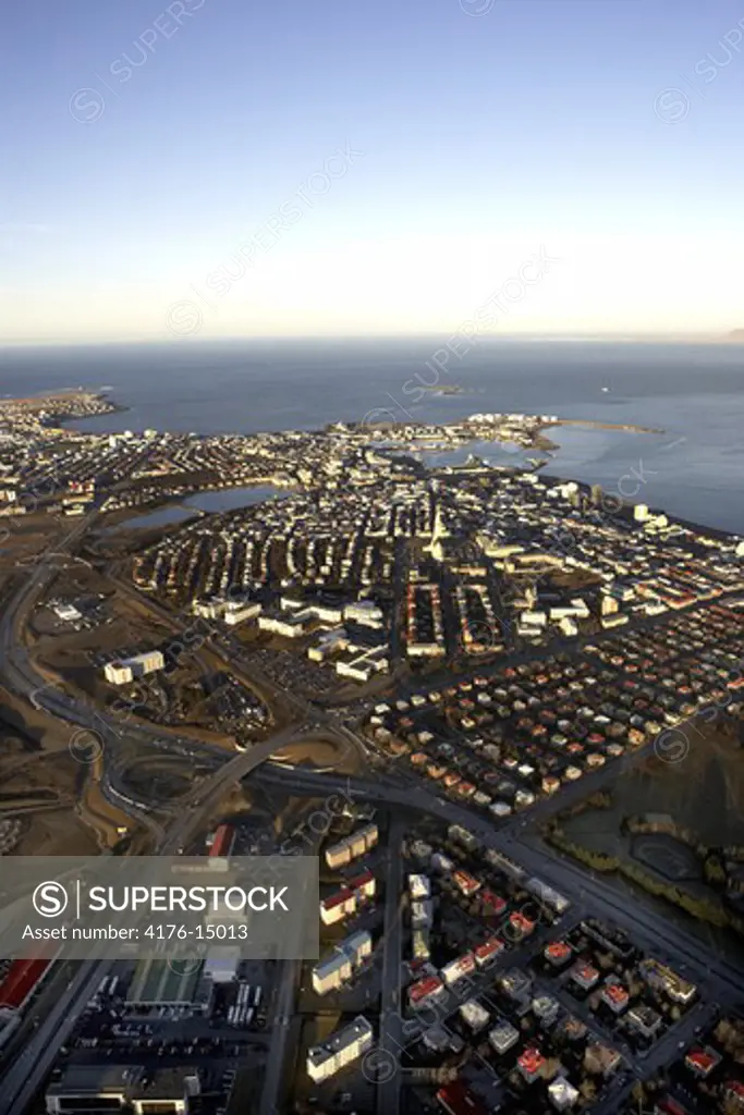 Aerial view of Reykjavik city with buildings, roads and sea
