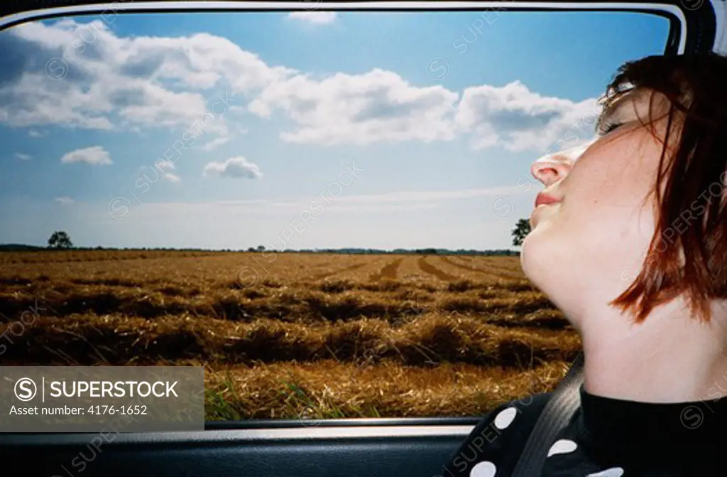 A woman sleeping in a car
